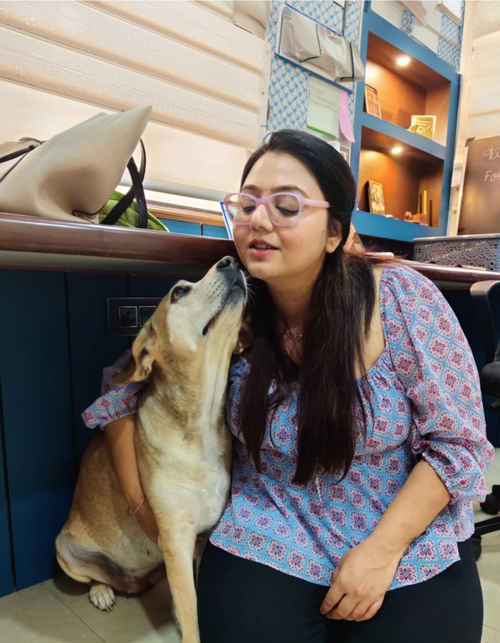 Kukky founder sitting with her dog